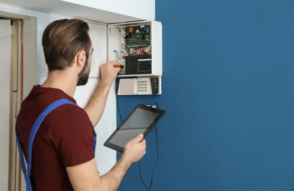 man servicing an alarm system
