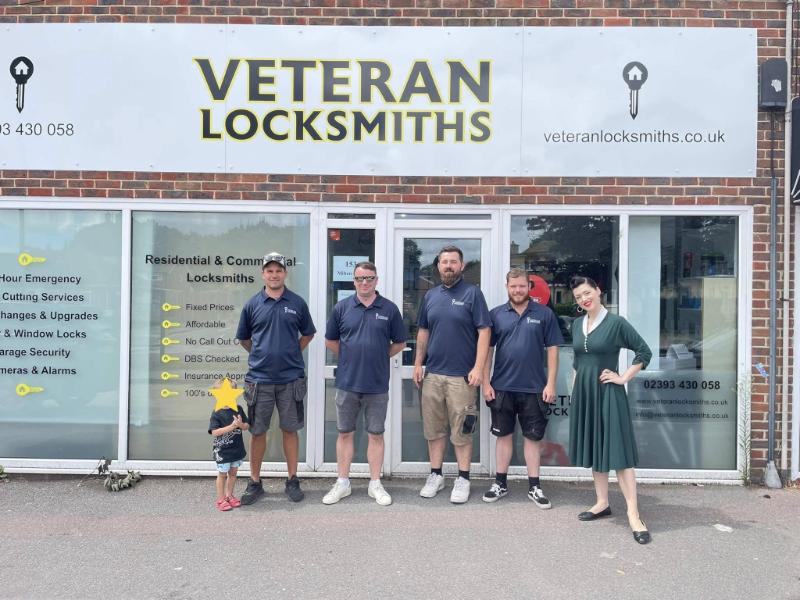 locksmiths standing outside their locksmith shop
