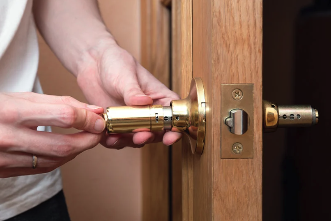 locksmith putting in a new lock